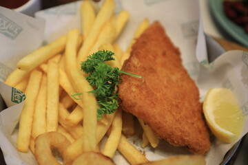 Grilled chicken breast served with crispy French fries, a fresh salad, and a side of tangy barbecue sauce is perfect for food lovers and culinary enthusiasts.