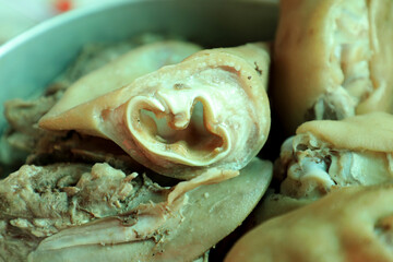 A close-up of boiled pig trotters, showcasing the texture and detail of traditional Asian cuisine, is ideal for food-related content and culinary presentations.
