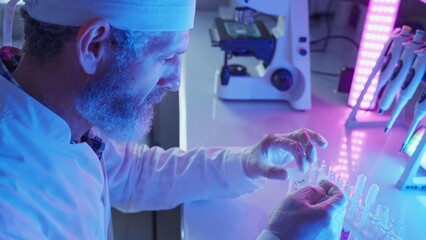 Chemist Analyzing Samples in Innovative Laboratory With Neon Purple Technology