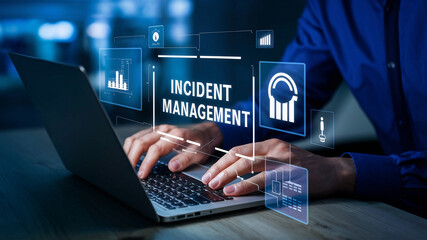 Incident Management in business tech involves swiftly diagnosing and resolving unexpected issues. A businessman uses a laptop with a virtual incident management icon.