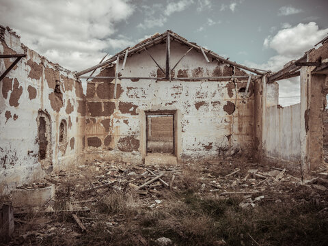 Ruins of an Abandoned Building Under Cloudy Sky
