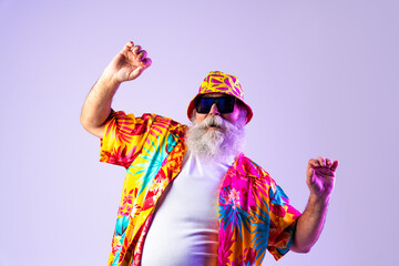 Senior old man tourist with gray beard  wearing tropical shirt portrait in studio - Funny stylish...