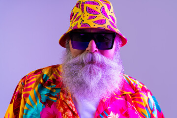 Senior old man tourist with gray beard  wearing tropical shirt portrait in studio - Funny stylish...