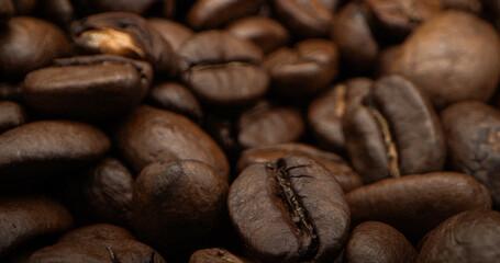 A heap of coffee beans stacked together, ready to be brewed into a delicious cup of coffee .Close-up of roasted Arabica coffee beans .Different types of delicious coffee beans
