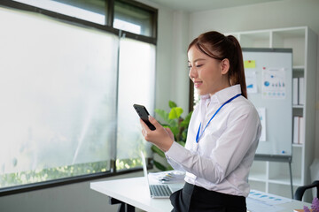 Young Accountant Using Telephone While Doing Paperwork in Modern Office Setting