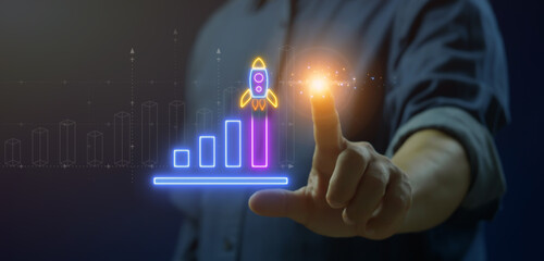 Businessman showing neon illustration rocket take of with growth up neon bar graph chart. The...