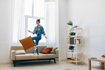 Joyful Woman Jumping with Music in Home Apartment