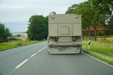 Completely dirty trailer of a motor vehicle. The license plate is completely covered in dirt and dust and cannot be read while traveling on a federal highway. License plate completely unrecognizable.