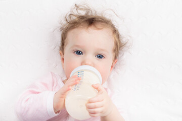 Little baby on white bed