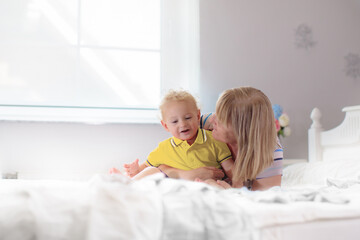 Mother and baby on a white bed