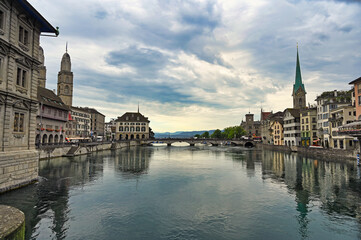 Fototapeta premium Zurich old town view from the river area with the view of Grossmunster and Fraumunster church clock towers.