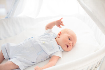 Little baby on white bed