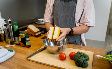 Chef at the kitchen preparing tofu scramble with vegetables