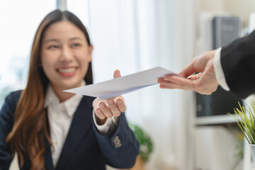 Close up view of office worker receiving salary from boss.