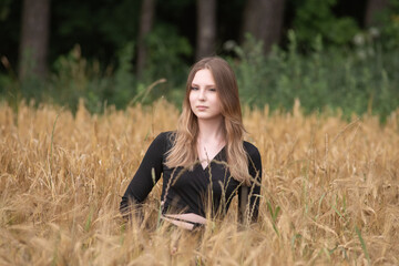 Portrait of a young beautiful long-haired girl in nature.