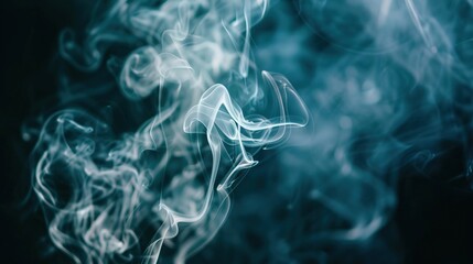 Fototapeta premium Gentle tendrils of white smoke with hints of blue, softly drifting across a dark background.