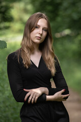 Portrait of a young beautiful long-haired girl in nature.