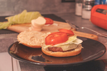 High angle view of a kitchen with delicious veggie burger with lettuce, and tomato to be prepared