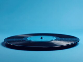 Black Vinyl Record on Blue Surface