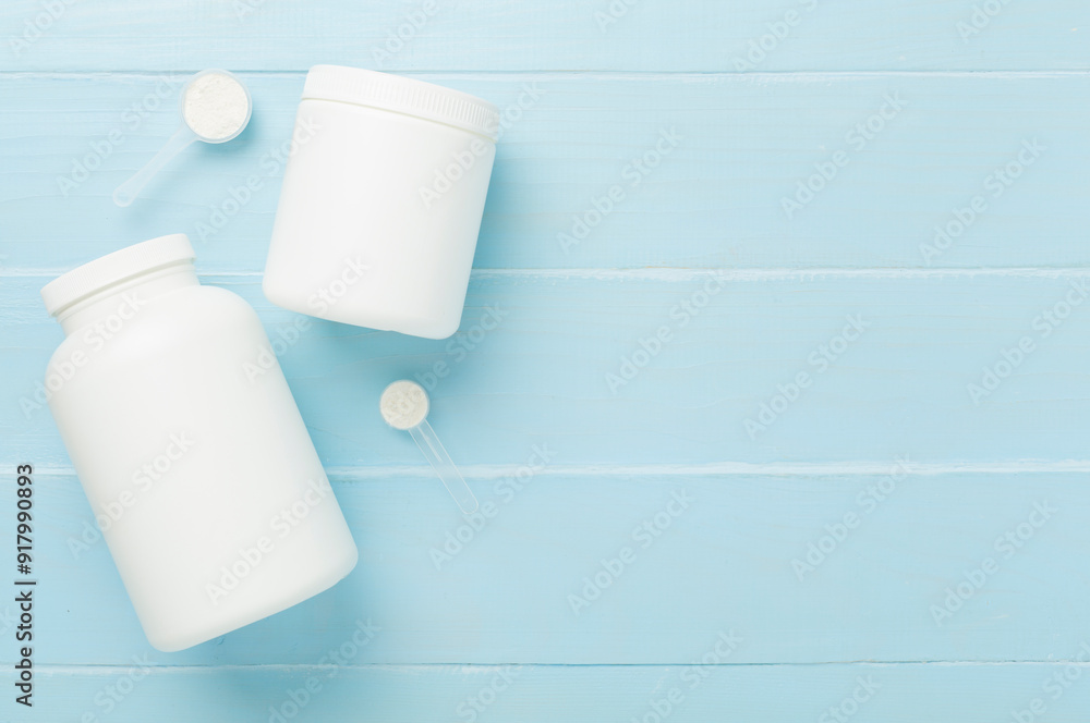 Sticker Jar with protein powder on wooden background, top view. Sports nutrition concept