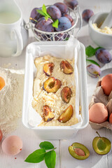 Ingredients for plum cake with local fruits and crumble.