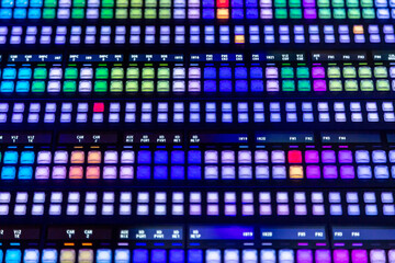 Modern video mixer panel with many colored, glowing buttons. Professional video and sound mixer...
