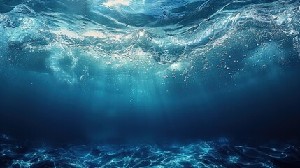 The dark blue sea surface seen from underwater