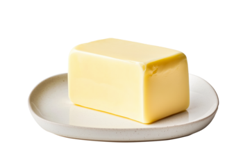 A block of fresh creamy butter on white plate isolated on white transparent background.