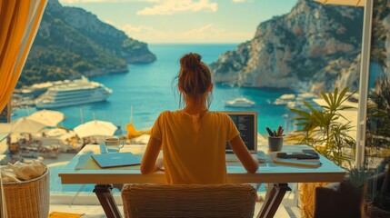 A woman is sitting at a desk with a laptop and a cup of coffee