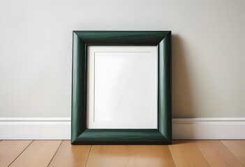 A black picture frame on a wooden floor against a white wall
