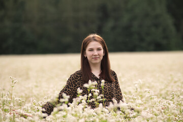 Portrait of a young beautiful long-haired girl in nature.
