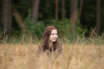 Portrait of a young beautiful long-haired girl in nature.