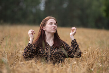 Portrait of a young beautiful long-haired girl in nature.
