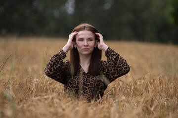 Portrait of a young beautiful long-haired girl in nature.