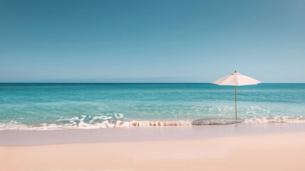 Fototapeta premium White Umbrella on Sandy Beach With Turquoise Water Under Clear Sky