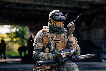 UAV Army operator in FPV glasses controls drone with bomb to drop into enemy fortifications and...