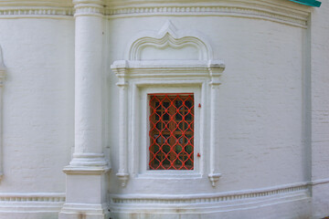 Vintage window on the external facade of a large wall of a building