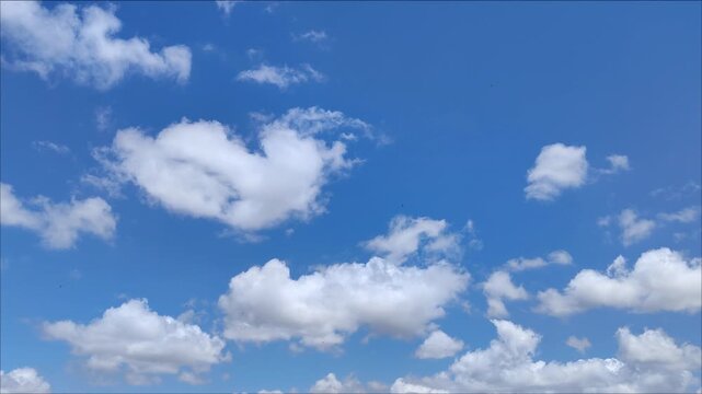 Beautiful white cumulus clouds moving in the middle of the day