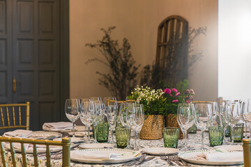 Elegant restaurant table setting with glassware and floral centerpiece