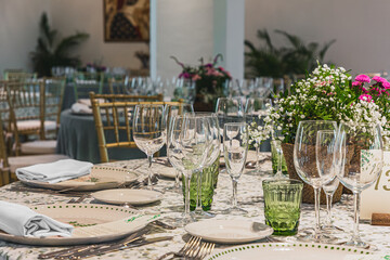 Elegant restaurant table setup with glassware and floral decorations.