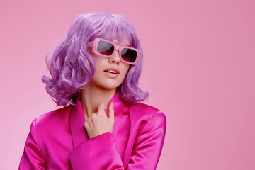 Purplehaired woman wearing sunglasses and a pink robe, standing against a pink background, exuding a vibrant and stylish vibe