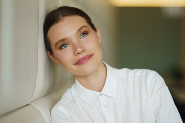 Businesswoman dreaming about the future sitting on a comfortable cafeteria