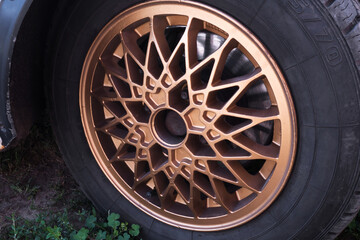 old retro titanium bronze car rims in the yard in summer