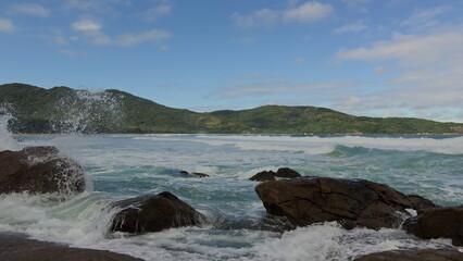 Slow-motion video of ocean waves hitting a tropical island coast