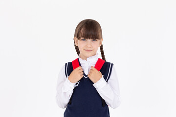 Indoor picture of young good-looking teenage girl isolated on white background in school uniform,...