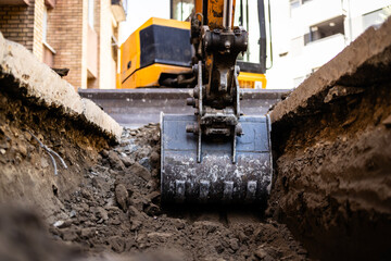 Excavator on construction site. Backhoe digging soil for construction business.