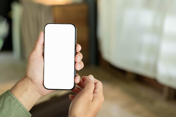 cell phone blank white screen mockup.hand holding texting using mobile on desk at office.background...