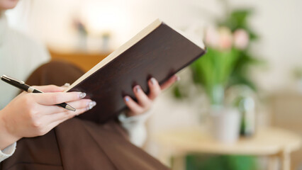 Closeup hands of young asian women holding the book to reading and learning about education while...