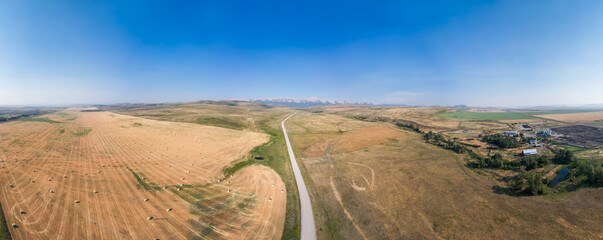 Dirt Road in Country side by farms. Alberta, Canada.