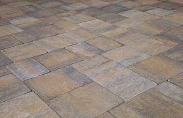 Brown and gray concrete paver blocks of different shapes. Stone effect for outdoor flooring, backyard or sidewalk. Background and texture.